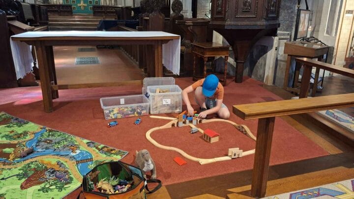 A child playing with toys in the church